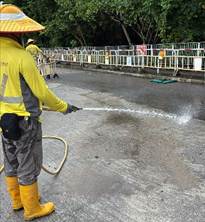 A person spraying water on the road
AI-generated content may be incorrect.