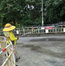 A person wearing a yellow hat and holding a hose

AI-generated content may be incorrect.